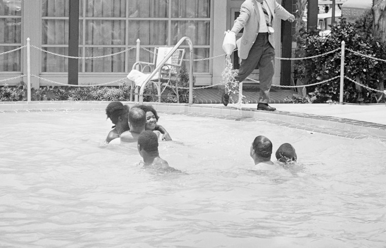 When a group of white and African American integrationists entered a segregated hotel pool, manager James Brock poured acid into it, shouting "I'm cleaning pool," on June 18, 1964, St. Augustine, Fla.