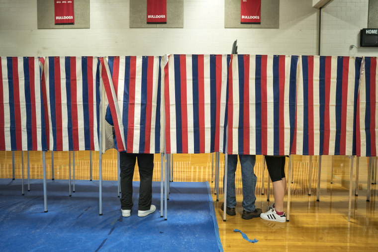 Image: Voters head to the polling booths inside Bedford High school