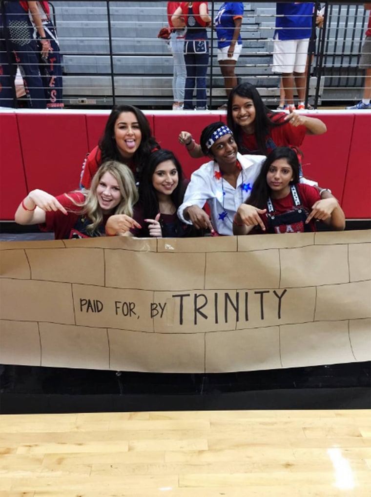 Image: Students with a pep rally sign that depicts the "wall" Donald Trump wants to build along the Mexican border