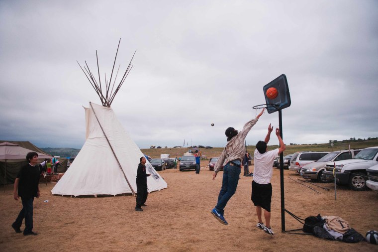 Image: Native American protesters play basketball in an encampment near the Standing Rock Sioux reservation