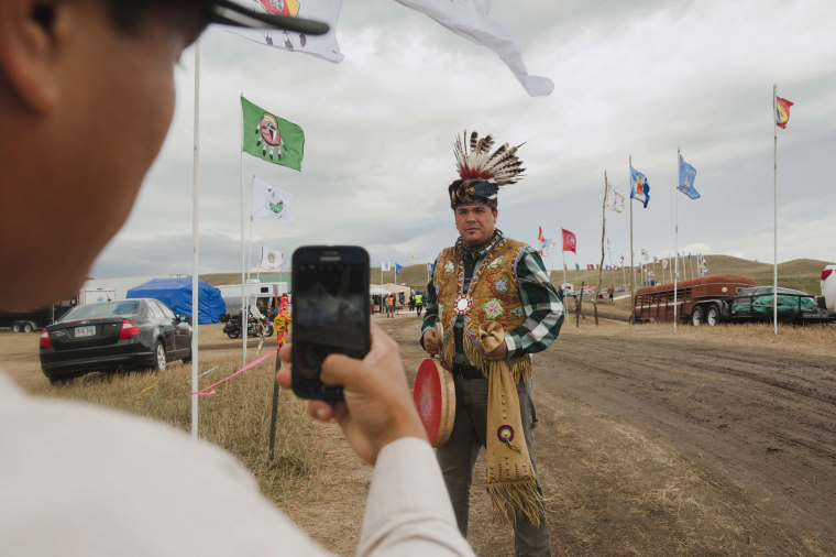 Image: Chivis takes a photo of his friend Syette after they travelled from the Saginaw Chippewa Reservation in Mount Pleasant, Michigan to join an encampment where hundreds of protestors have gathered on the banks of the Cannon Ball River