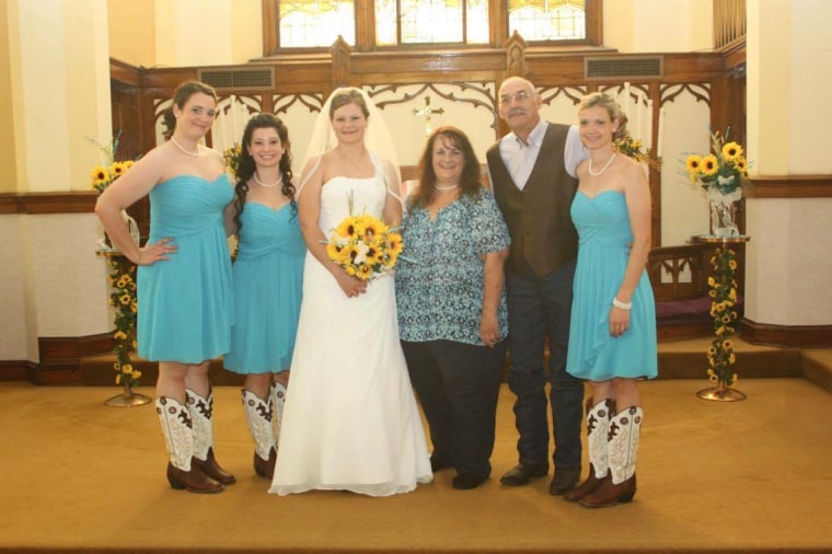 Lori, her husband Ron, and their four daughters at the wedding of their youngest daughter.