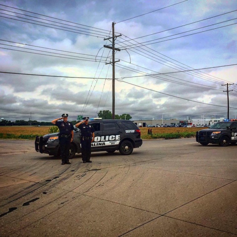 Local police salute Lori’s casket during the funeral procession.