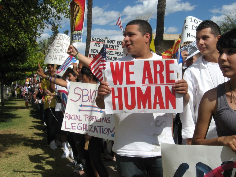 Students walked out of high school with "We Are Human" signs to protest at the Arizona State Capitol after SB 1070 was signed into law in 2010.