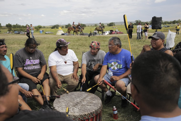 Image: The Creekside Singers from Pine Ridge Reservation drum while camped out with other protesters near the site of a planned road that would be used in constructing a portion of the Dakota Access oil pipeline, in Cannon Ball, N.D.