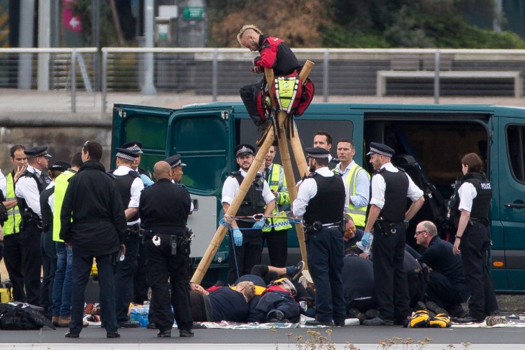 Image: Emergency services surround protesters at London City Airport