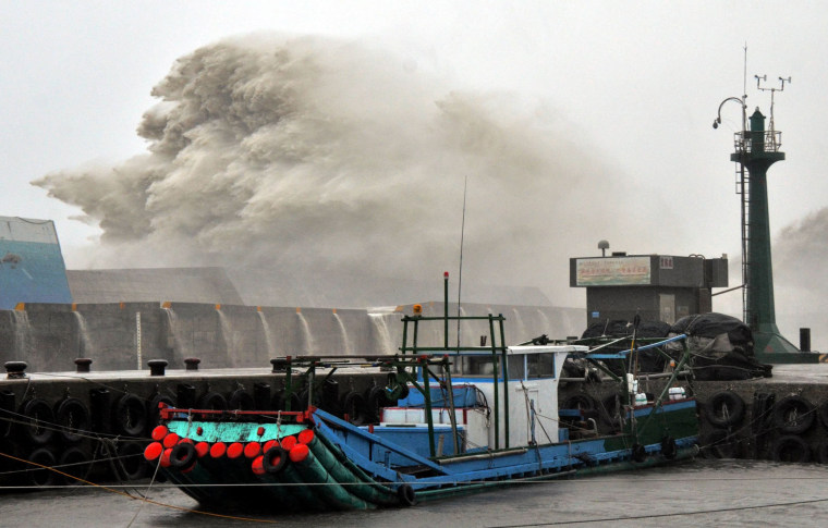 Image: A huge wave breaks over infrastructure at the fishing port in southern Taitung