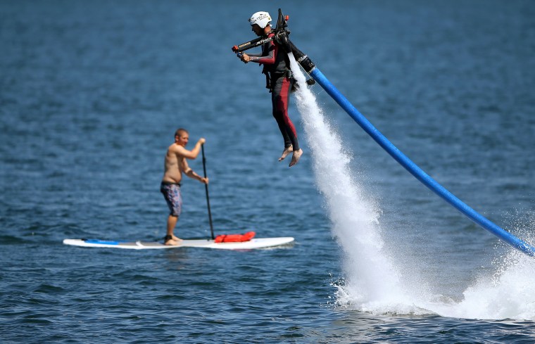 Image: U.S. military veteran Joshua Alves shoots out of the ocean on a water jetboard as part of an event by Warrior Passion and Jetpack America in San Diego