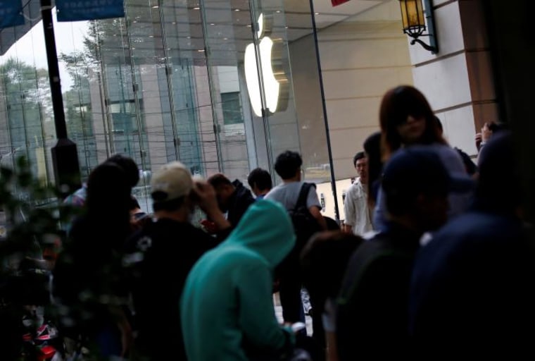 Image: Customers wait for the release of Apple's new iPhone 7 in Tokyo.