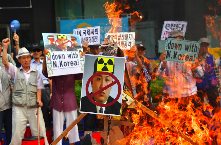 Image: South Korean activists set fire to a portrait of North Korean leader Kim Jong Un