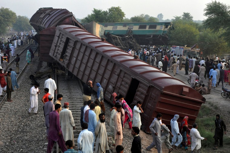 Image: Locals gather at the scene where two trains collided near Multan