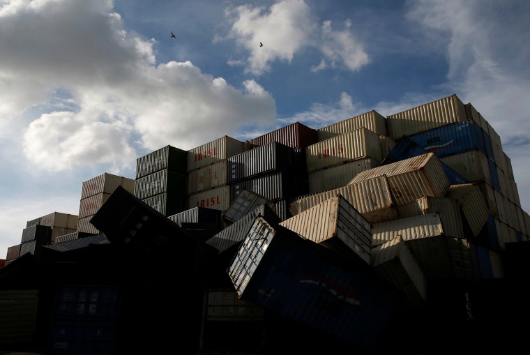 Image: Birds fly over the toppled shipping containers after Typhoon Meranti made landfall, in Kaohsiung