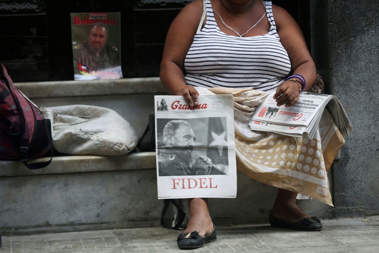 Image: Eoman sells Cuban Communist Party (PCC) official newspaper Granma with a picture of former Cuba's President Fidel Castro at the front page, at the main touristic road in Havana