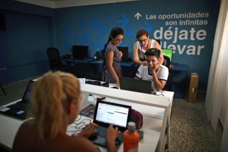 Employees work at the office of the media platform OnCuba in Havana on Aug. 2.