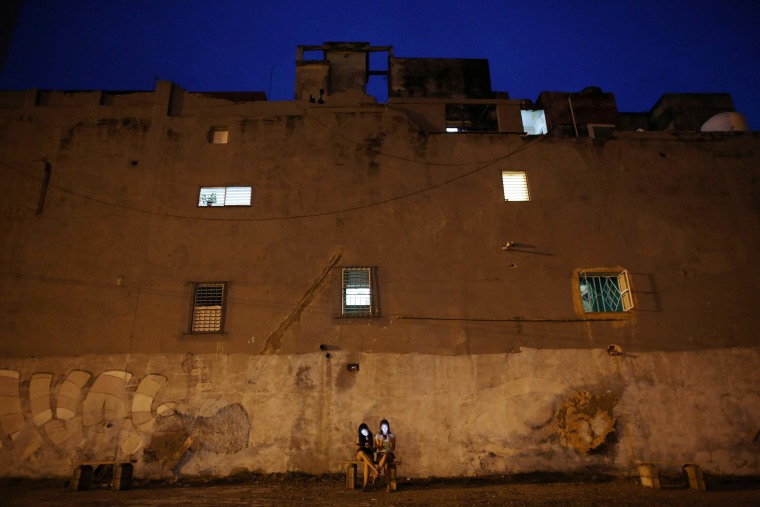 Image: Gabriela Monteiro and Gisele Rodriguez use the internet at a hotspot in Havana, Cuba