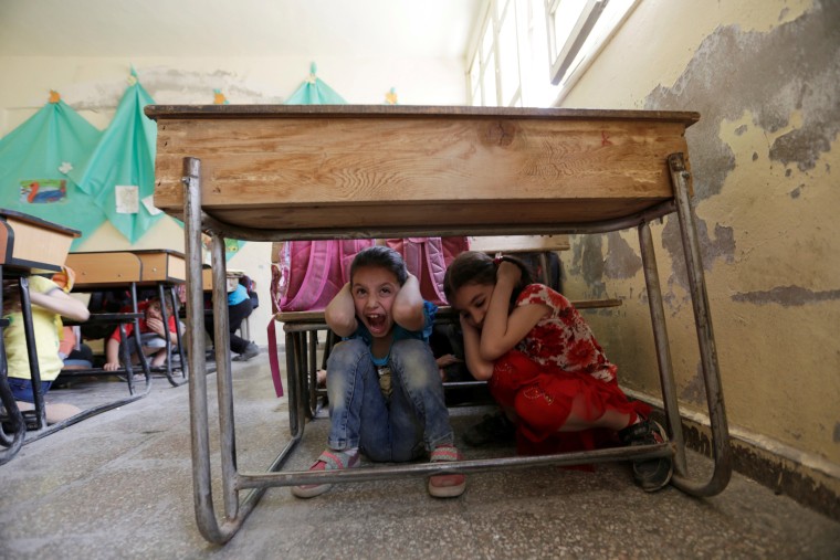 Image: Children attend a war safety awareness class conducted by civil defence members, in the rebel-controlled area of Maaret al-Numan town in Idlib province