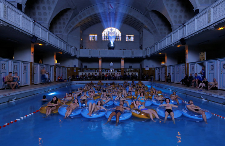 Image: People attend the screening of the film \"Jaws\" by director Steven Spielberg, screened at Strasbourg public baths during the European Fantastic Film Festival, in Strasbourg