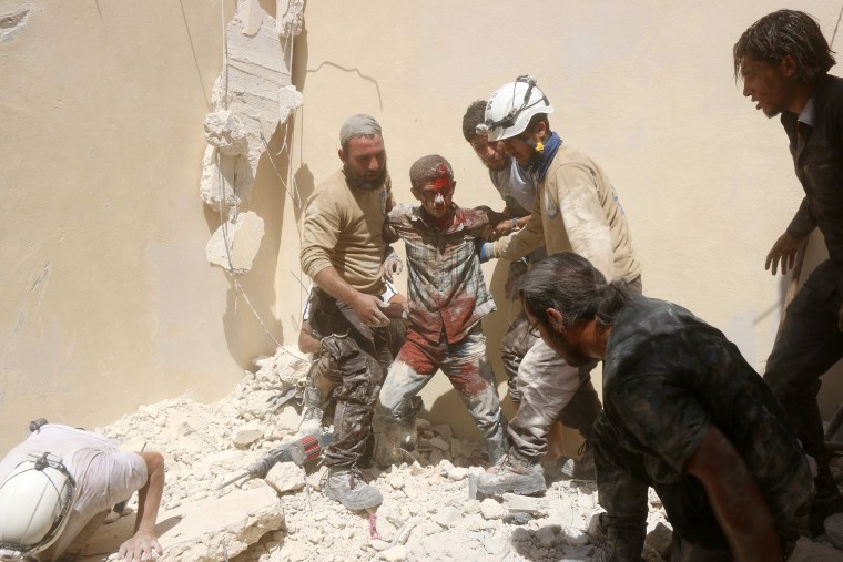 Image: A man rescued from rubble in Aleppo