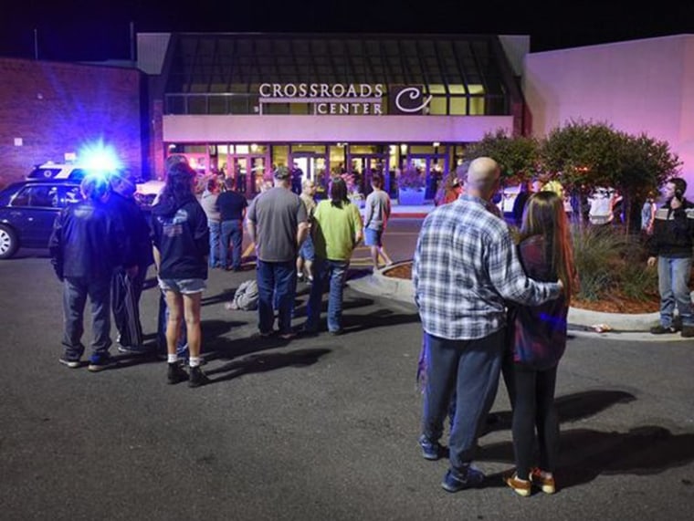 Image: People stand near the entrance on the north side of Crossroads Center mall