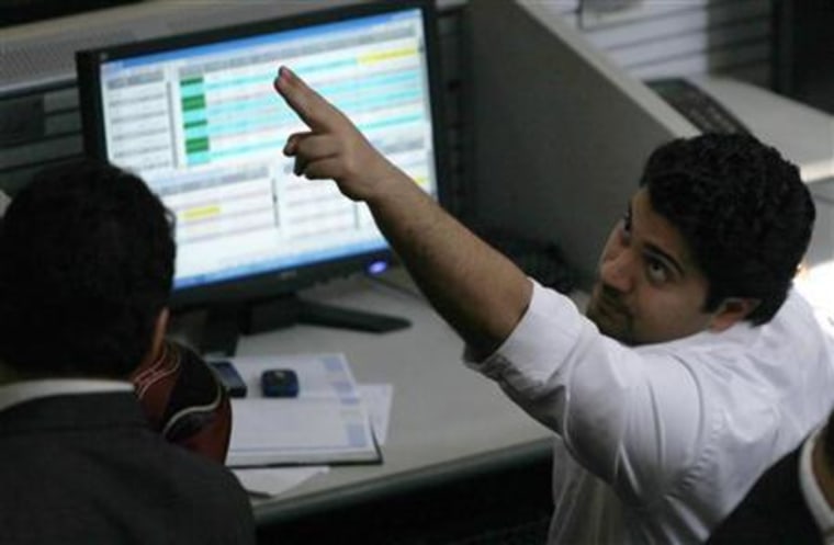 Traders work at the Egyptian stock exchange in Cairo