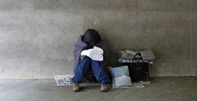 A homeless person sits in a subway station near the White House in Washington
