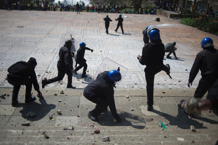 Image: Security guards from the University of the Witwatersrand pelt students with stones
