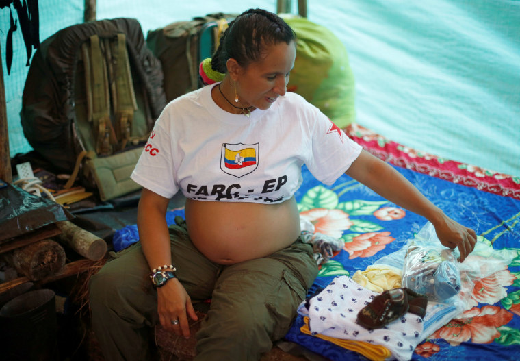 Image: FARC's Tatiana sits beside gifts for the baby at a camp where the FARC will ratify a peace deal with the Colombian government, near El Diamante in Yari Plains