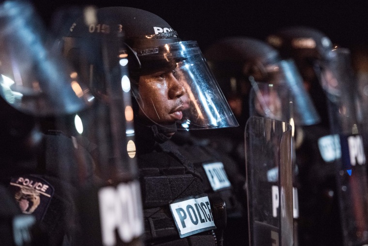 Image: Police officers hold their line on I-85 during protests