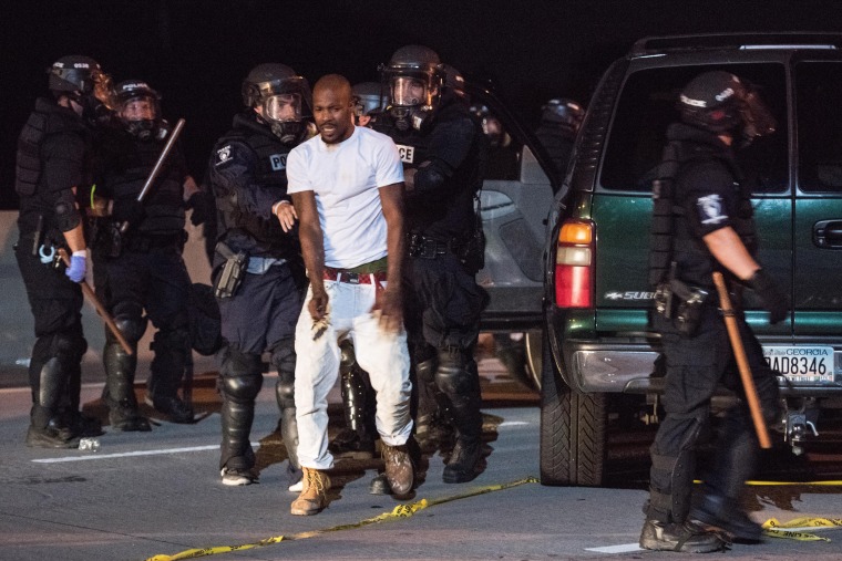 Image: Police officers remove a man from his vehicle on I-85 in Charlotte