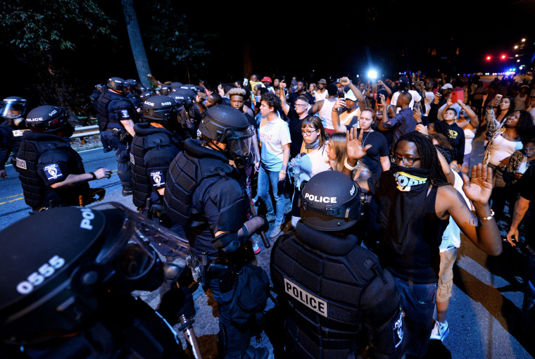 Image: Police officers form a line in front of protesters in Charlotte