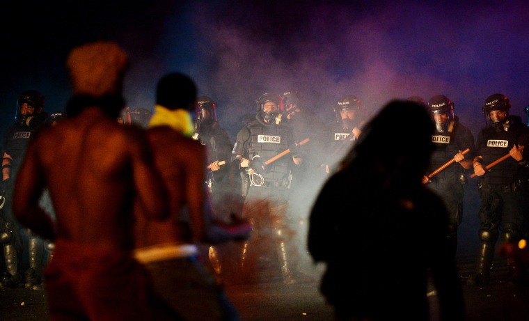 Image: Officers stand in formation in front of protesters in Charlotte