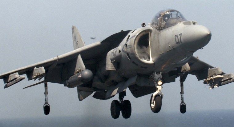 Image: A United States Marine Corps AV-8B Harrier jet makes a vertical landing on the deck of the British strike carrier HMS Illlustrious
