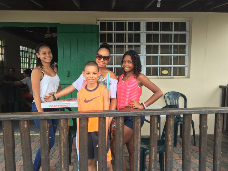 Michelle Skerrett, 46 with her three kids in Luquillo, Puerto Rico.