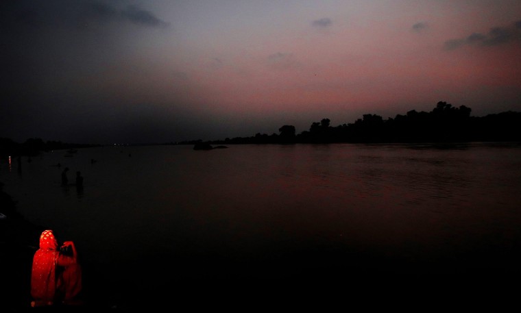 Image: A woman sits at the bank of river Ravi as the sunsets in Lahore
