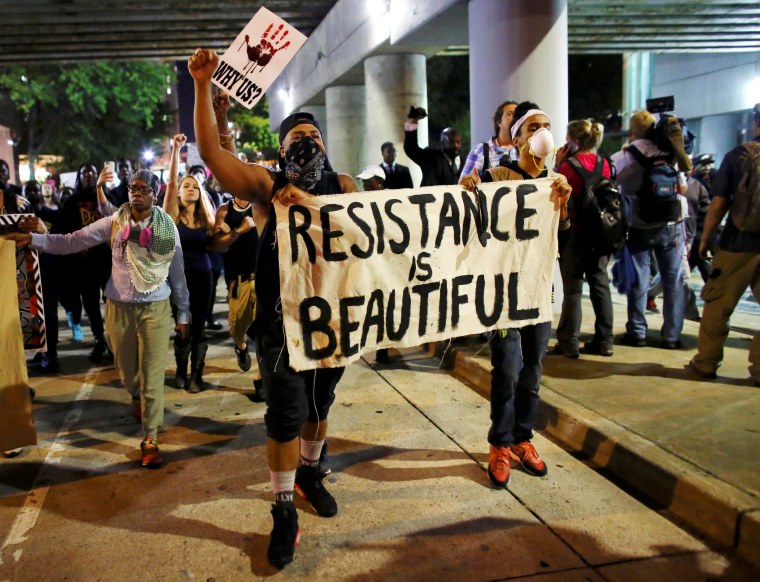 Image: Protesters walk in the streets downtown during another night of protests over the police shooting of Keith Scott in Charlotte