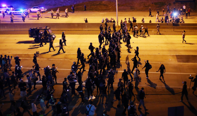 Image: Riot police push protesters off the highway during another night of protests over the police shooting of Keith Scott in Charlotte