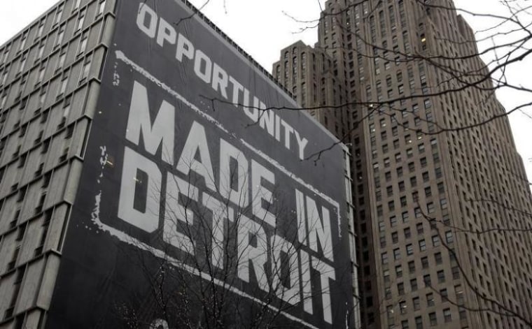 A large \"Opportunity Made In Detroit\" banner is seen on the side of one of the buildings owned by Quicken Loans founder Gilbert in downtown Detroit