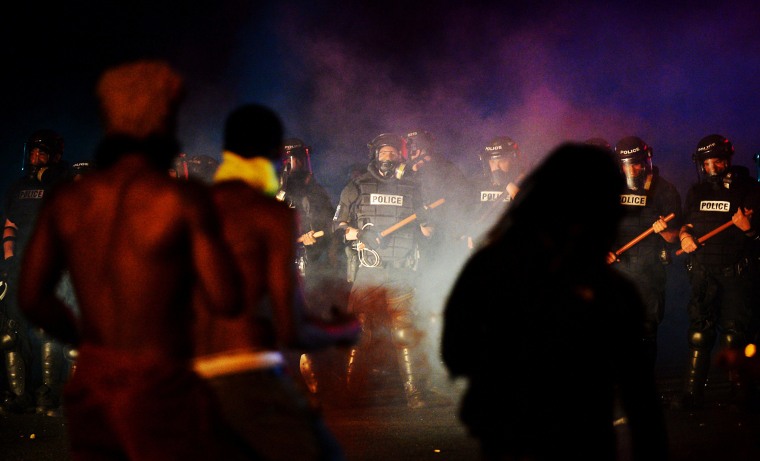 Image: Officers stand in formation in front of protesters in Charlotte, N.C.