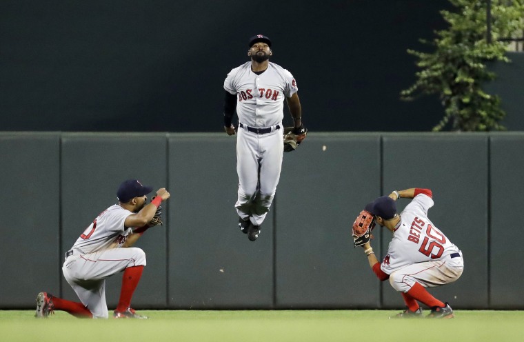Image: Boston Red Sox outfielders celebrate after a baseball game
