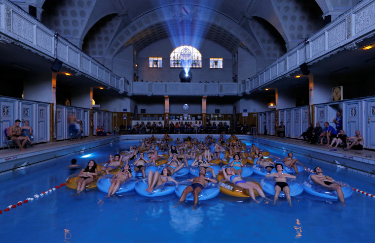 Image: People attend the screening of the film \"Jaws\" by director Steven Spielberg, screened at Strasbourg public baths during the European Fantastic Film Festival, in Strasbourg