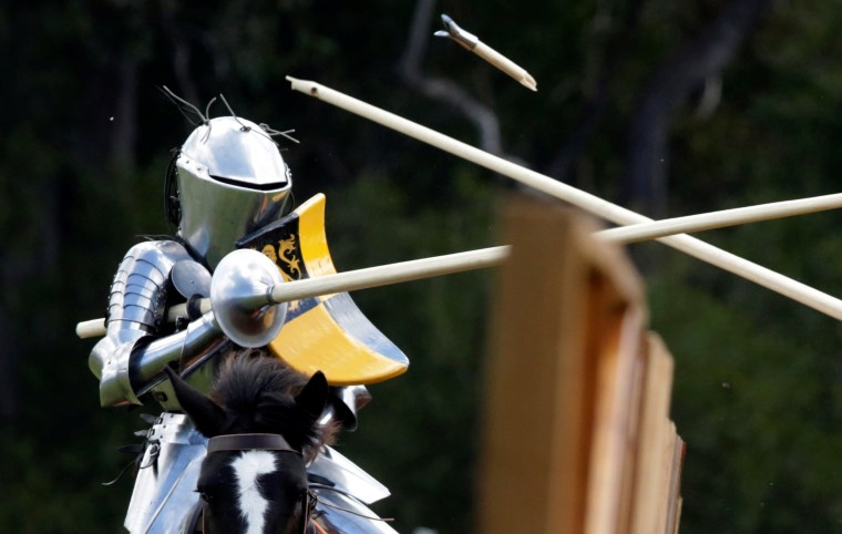 Image: Australian jouster Luke Binks has a lance break off his body during the jousting tournament at the St Ives Medieval Fair in Sydney