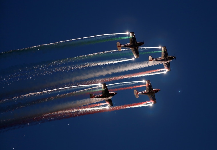 Image: The Pioneer Team, a civil aerobatic team from Italy, let off pyrotechnics from their Pioneer 330 aircraft during the Malta International Airshow