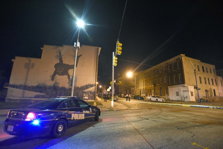 Baltimore police work the scene of the Saturday night shooting.