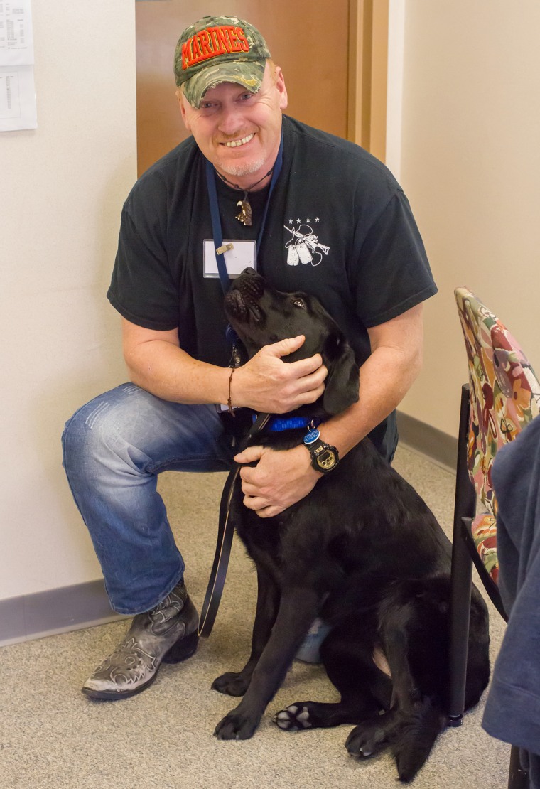 John Welch, and his service dog, a black lab named Onyx.