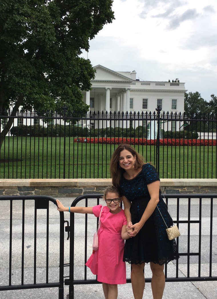 Cathy Areu, political pundit and ardent Democrat, with her 7-year-old daughter in front of the White House on a recent visit to Washington, D.C.