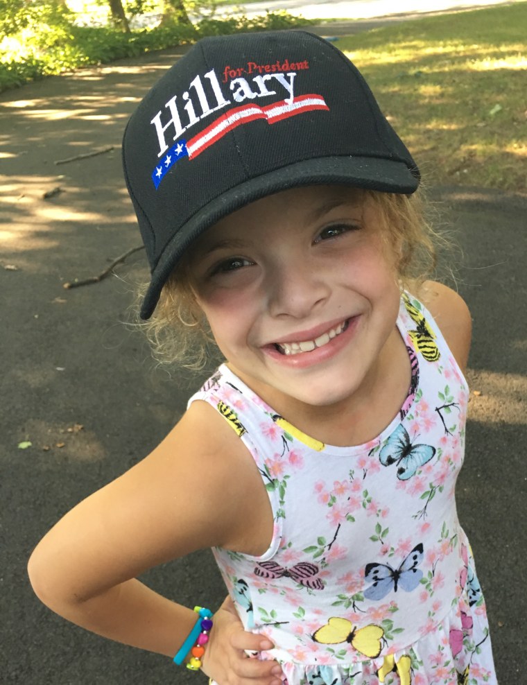 I'm with her! ... My mom, that is. Cathy Areu's daughter poses in a new hat that aligns with her politics. But trying to raise political mini-mes can backfire, Cathy discovered.