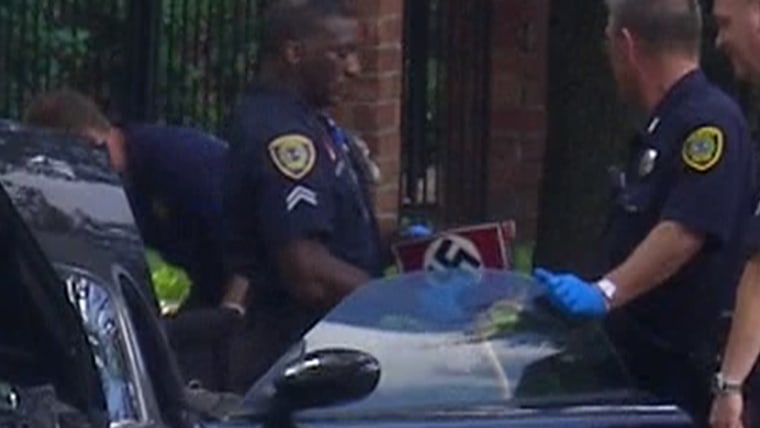 Houston police examine suspect in mall shooting's car and recover an item with a Nazi swastika on it.