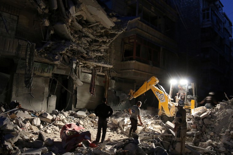 Image: Civil Defense members search for survivors at a site hit by an airstrike in the rebel-held al-Shaar neighbourhood of Aleppo
