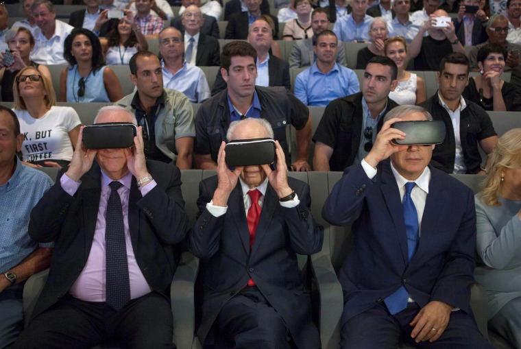 Image: Rivlin, Peres and Netanyahu wear virtual reality goggles during a ceremony at the Peres Center for Peace in Jaffa