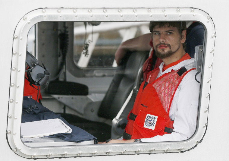 Image: Nathan Carman arrives in a small boat at the US Coast Guard station in Boston